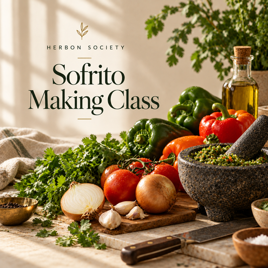 Fresh Puerto Rican sofrito ingredients including peppers, onions, garlic, cilantro, and culantro arranged around a bowl of green sofrito.